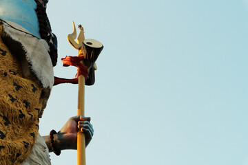 Shiva's hand holds a trident with a drum. Fragment of a huge statue of Shiva with space on the...