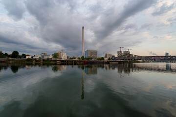 Fototapeta na wymiar Seine river quay, power plant chimney and construction site in Grand paris area. Ivry-sur-Seine city