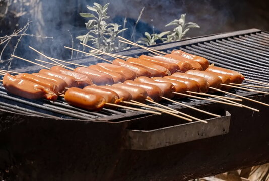 Grilled sausages on bamboo sticks