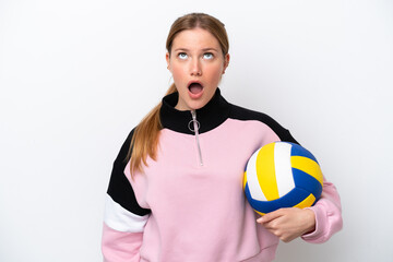 Young caucasian woman playing volleyball isolated on white background looking up and with surprised expression