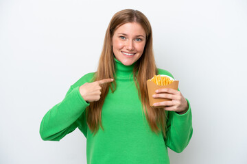 Obraz premium Young caucasian woman holding fried chips isolated on white background with surprise facial expression
