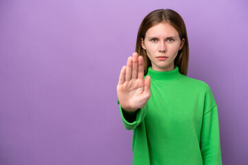 Young English woman isolated on purple background making stop gesture