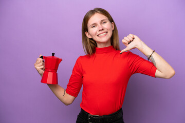 Young English woman holding coffee pot isolated on purple background proud and self-satisfied