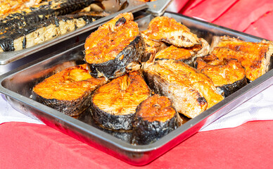 Appetizing grilled fish on a metal tray