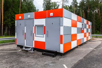 Modular public toilet stand on the parking lot