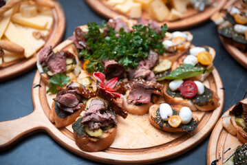 Toasted sandwiches with meat, vegetables, quail eggs, and lettuce