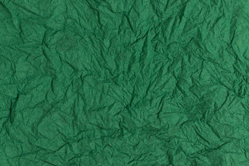 Green crumpled paper background. Full frame texture.