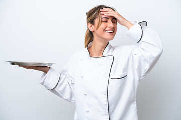 Young chef woman with tray isolated on white background smiling a lot