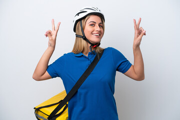 Young caucasian woman with thermal backpack isolated on white background showing victory sign with both hands