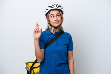 Young caucasian woman with thermal backpack isolated on white background with fingers crossing and wishing the best