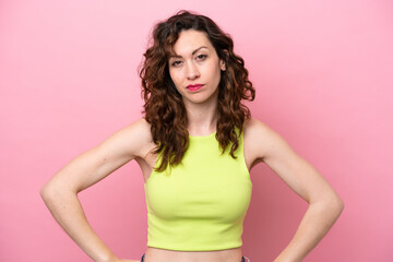 Young caucasian woman isolated on pink background angry