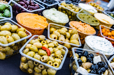Olives in plastic boxes put up for sale in the store