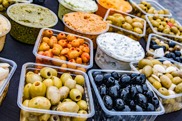 Olives in plastic boxes put up for sale in the store
