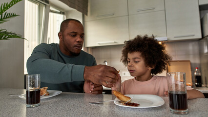 Fototapeta na wymiar Father give pizza slice to son during have lunch