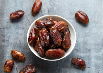 Organic dried Dates fruit in white bowl