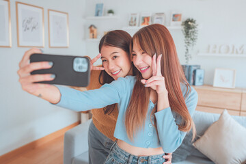 Two happy asian women blogger shooting social media stories or video calling in mobile app and...