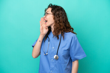 Young nurse caucasian woman isolated on blue background shouting with mouth wide open to the lateral
