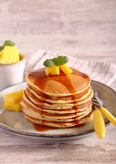 Pile of pancakes with pineapple