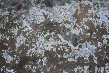 Old stone wall with remains of paint, cracks