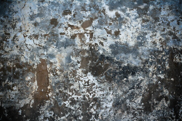 Old stone wall with remains of paint, cracks