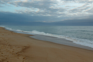 Fototapeta na wymiar Sand and ocean with sky