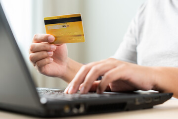 Woman using laptop for online shopping by credit card. Cashless payment using laptop.
