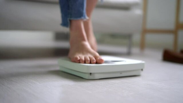 Scale Woman Feet Standing On Weight Scale In Bathroom
