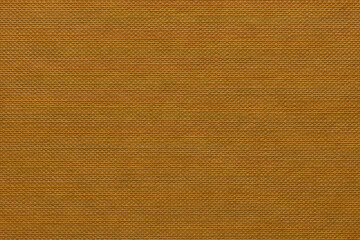 Extreme close-up orangey brown hardback book cover showing pattern of dimples nodules in rows