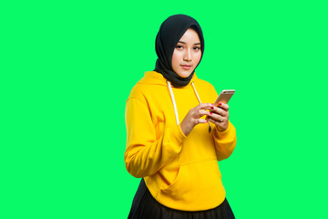 beautiful asian moslem girl smile and holding her phone