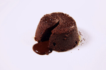 Delicious fondant with hot chocolate on white plate. Lava cake. Chocolate cake with clipping path. Molten chocolate cake. Side view