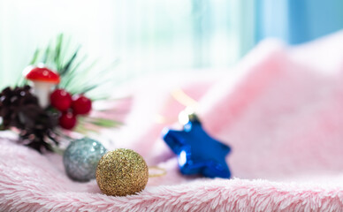 Golden and Silver Christmas ball on Pink Sweater with Overlight from Window Background,for Merry Christmas and Happy New Year 2023 Concept,Free Space for Presentation,Celebration Xmas Decoration. - obrazy, fototapety, plakaty