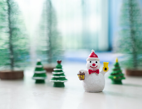 Funny Snowman on Blur Christmas Tree Background,Card or Poster for Merry Christmas and Happy New Year 2023 Concept,Free Space for Presentation,Celebration Xmas Decoration Festive Holidays.