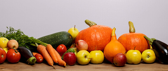 Autumn still life with a harvest of pumpkins, apples, eggplants, zucchini, carrots, cucumbers, tomatoes