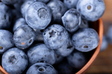 Freshly picked blueberries in  bowl. Bilberry on wooden Background. Blueberry antioxidant. Concept for healthy eating and nutrition