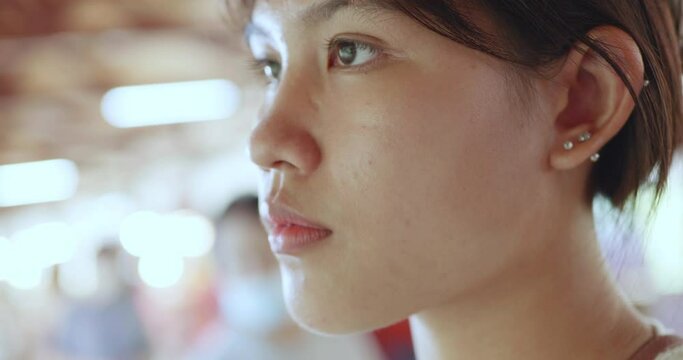 Close-up of an Asian woman in the city
