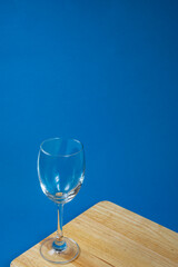 Top view of empty glasses on a wooden board with a blue background, Wine glasses, Dinner and party concept.
