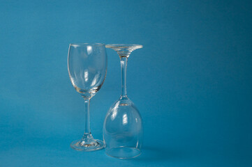 Two empty glasses with a blue background, Wine glasses, Dinner and party concept.