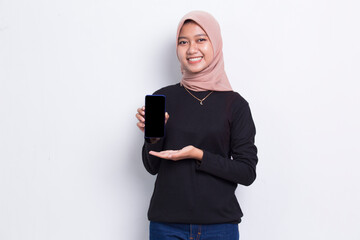 young beautiful asian muslim woman demonstrating mobile cell phone isolated on white background
