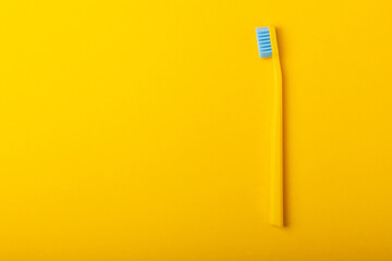 Toothbrushes. Oral care. Dental care. Composition with bright toothbrushes on a yellow...