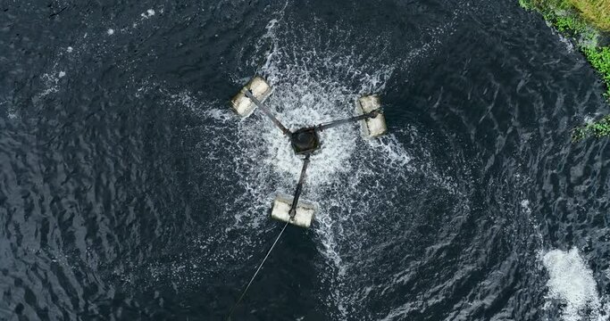 Waste water and electric motor turbine use treatment wastes increased oxygen by motor electric energy for return the fresh air to nature footage slow motion circle up camera from drone aerial view, 