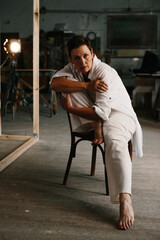 Portrait of a woman in a film studio with lighting equipment.