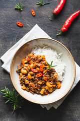 Chili Con Carne in bowl on dark background. Mexican cuisine. chili con carne - minced meat and vegetables stew in tomato sauce. Top view