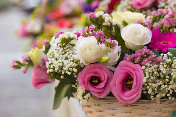 Spring flower arrangement in basket with various colours
