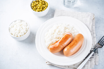 Fried sausages with rice in a plate