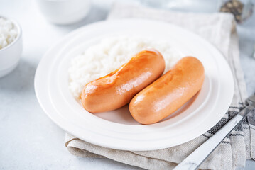 Fried sausages with rice in a plate