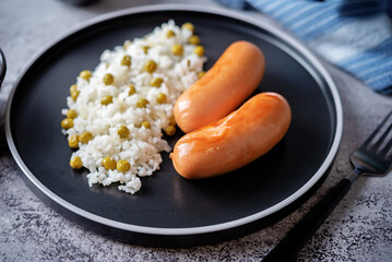 Fried sausages with rice in a plate
