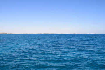 Vacation, travel, holiday, trip to Egypt. View from Red sea to coast against clear blue sky. Peaceful seascape. Copy space. Selective focus.