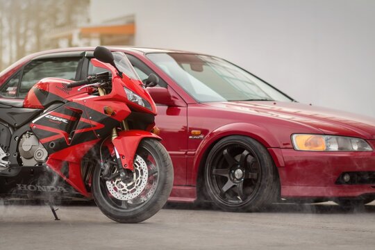 KRASNOYARSK, RUSSIA - April 3, 2020: Red Honda Accord EuroR CL1 sports car and the Honda CBR 600 RR sportbike