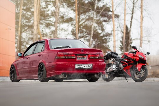 KRASNOYARSK, RUSSIA - April 3, 2020: Red Honda Accord EuroR CL1 sports car and the Honda CBR 600 RR sportbike