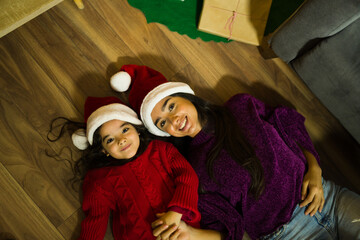 Fototapeta premium Mom and kid playing on the floor during christmas holidays